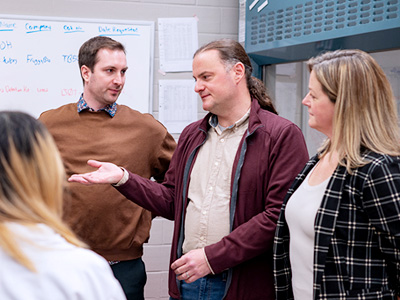 Patrick O'Donoghue speaks with members of his research lab