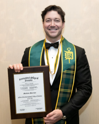 Matthew Morrison holding a plaque